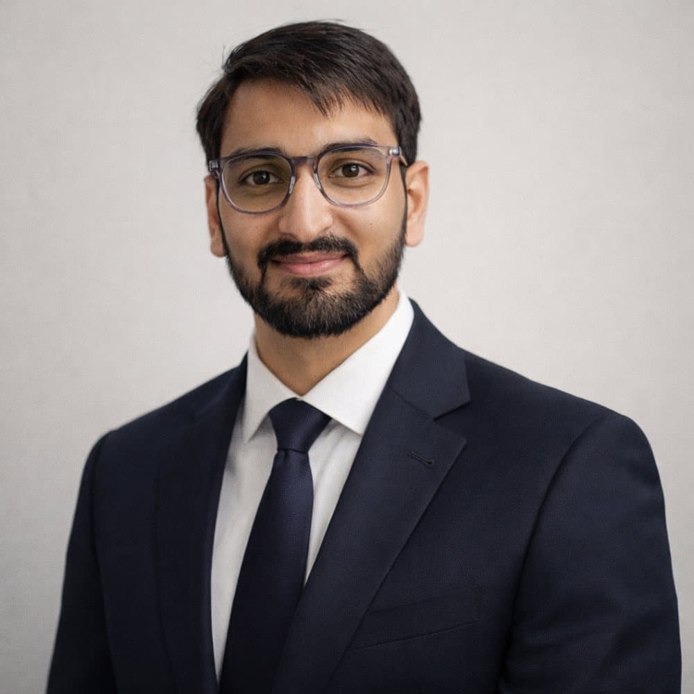 Ashutosh Shrivastava, founder of WOOKhoop, in a navy suit and glasses.